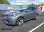 2018 Hyundai Santa Fe 2.4L z VIN 5NMZU3LBXJH098272, wystawiony jako IAAI lot #43375252 z przebiegiem 96 576 mil mil oraz . Historia ofert i sprzedaży dostępna na DreamBid. Obrazek 18.