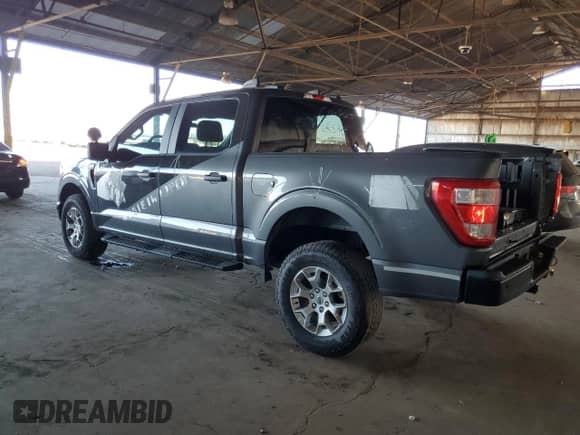 2023 Ford F-150 with VIN 1FTFW1P89PKD31166, listed as a Copart auction lot 84958565 with 50,773 mi miles and Salvage title. Bid and sale history available at DreamBid. Image 2.