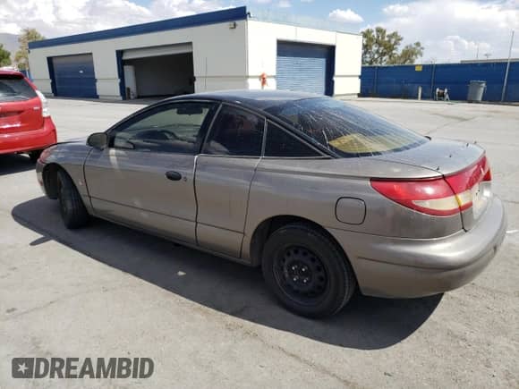 1999 Saturn SC with VIN 1G8ZN1288XZ310351, listed as a Copart auction lot 76677414 with Not provided miles and Salvage title. Bid and sale history available at DreamBid. Image 2.