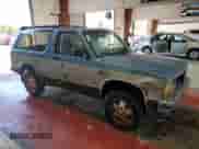 1990 Chevrolet Blazer with VIN 1GNCT18Z2L0107091, listed as a Copart auction lot 80714795 with 203,095 mi miles and Salvage title. Bid and sale history available at DreamBid. Image 4.