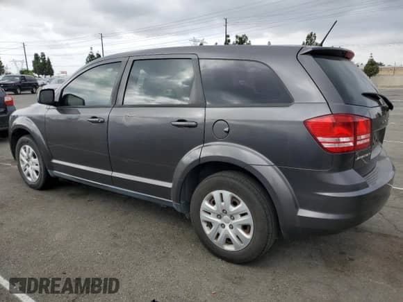 2015 Dodge Journey SE with VIN 3C4PDCABXFT587825, listed as a Copart auction lot 82462175 with 144,696 mi miles and Clean title. Bid and sale history available at DreamBid. Image 2.