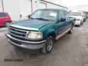 1997 Ford F-150 XL with VIN 1FTEX17LXVNC32588, listed as a IAAI auction lot 40848063 with 210,113 mi miles and . Bid and sale history available at DreamBid. Image 2.