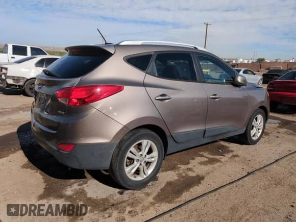 2011 Hyundai Tucson Limited with VIN KM8JUCAC1BU309681, listed as a Copart auction lot 54552335 with 180,444 mi miles and Salvage title. Bid and sale history available at DreamBid. Image 3.