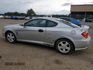 2003 Hyundai Tiburon GT с VIN KMHHN65F13U013420, выставлен на аукционе Copart как лот 51234495 с пробегом 230 612 миль миль и Списание • Salvage title. История ставок и продаж доступна на DreamBid. Изображение 2.