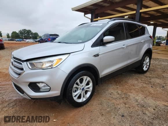 2018 Ford Escape SE with VIN 1FMCU9GD2JUB39549, listed as a Copart auction lot 84175385 with 127,811 mi miles and Salvage title. Bid and sale history available at DreamBid. Image 1.
