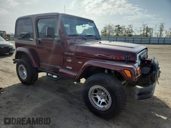 2002 Jeep Wrangler Sahara z VIN 1J4FA59S62P706936, wystawiony jako Copart lot #86420315 z przebiegiem 117 025 mil mil oraz Szkoda całkowita • Salvage title. Historia ofert i sprzedaży dostępna na DreamBid. Obrazek 4.