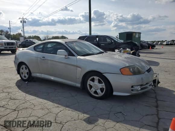 2003 Hyundai Tiburon GT z VIN KMHHN65F03U055237, wystawiony jako Copart lot #82400615 z przebiegiem 244 468 mil mil oraz Szkoda całkowita • Salvage title. Historia ofert i sprzedaży dostępna na DreamBid. Obrazek 4.