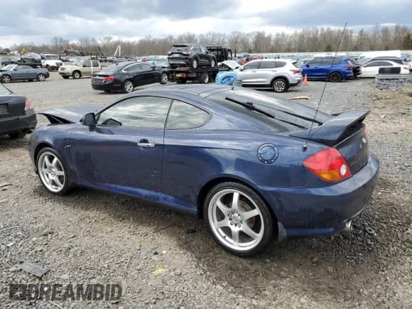 2004 Hyundai Tiburon GT с VIN KMHHN65F14U109145, выставлен на аукционе Copart как лот 51117385 с пробегом Не указан миль и Списание • Salvage title. История ставок и продаж доступна на DreamBid. Изображение 2.