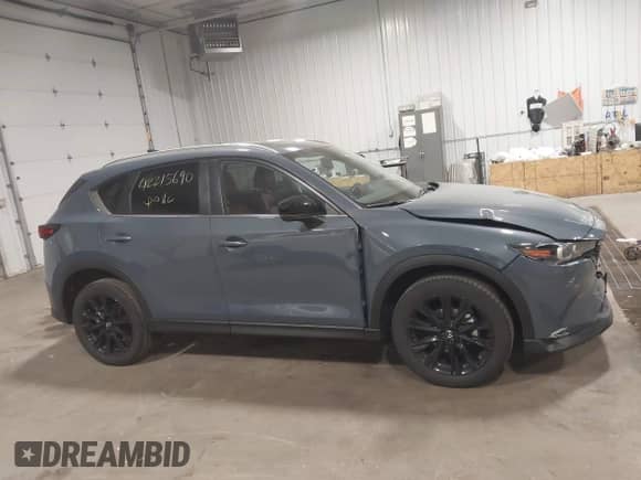 2023 Mazda CX-5 S Carbon Edition z VIN JM3KFBCM8P0261086, wystawiony jako IAAI lot #42215690 z przebiegiem 23 730 mil mil oraz . Historia ofert i sprzedaży dostępna na DreamBid. Obrazek 13.