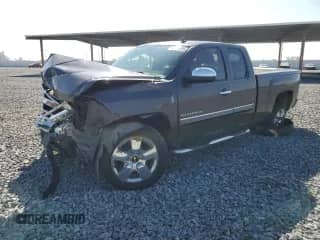 2011 Chevrolet Silverado 1500 LT with VIN 1GCRCSE00BZ145282, listed as a Copart auction lot 87397805 with 179,752 mi miles and Salvage title. Bid and sale history available at DreamBid. Image 1.