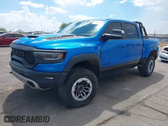 2022 Ram 1500 TRX with VIN 1C6SRFU96NN267610, listed as a IAAI auction lot 43033854 with 19,475 mi miles and . Bid and sale history available at DreamBid. Image 2.