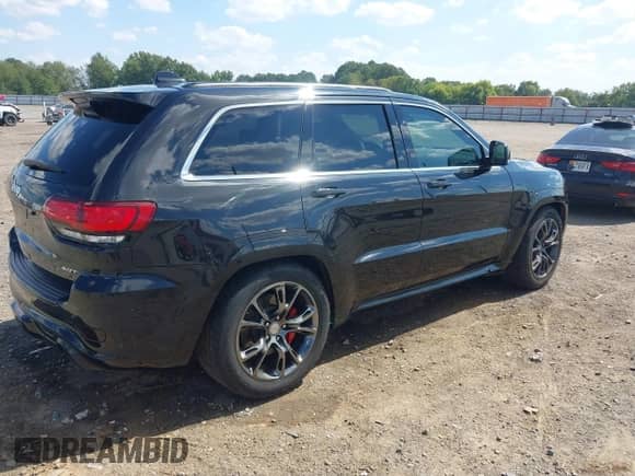 2015 Jeep Grand Cherokee SRT with VIN 1C4RJFDJ4FC853745, listed as a IAAI auction lot 43327828 with 68,614 mi miles and . Bid and sale history available at DreamBid. Image 4.