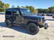 2000 Jeep Wrangler Sport with VIN 1J4FA49S1YP796600, listed as a Copart auction lot 82574545 with 128,340 mi miles and Clean title. Bid and sale history available at DreamBid. Image 4.