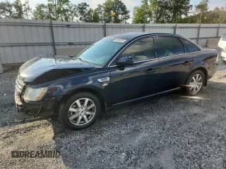2008 Ford Taurus SEL with VIN 1FAHP24W78G184094, listed as a Copart auction lot 69184285 with 243,776 mi miles and Salvage title. Bid and sale history available at DreamBid. Image 1.