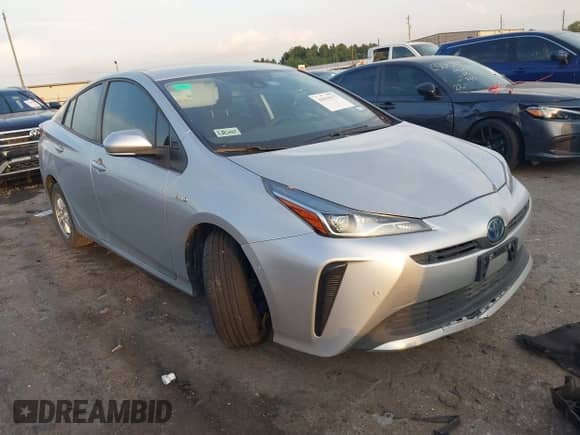 2021 Toyota Prius L Eco with VIN JTDKAMFUXM3143243, listed as a IAAI auction lot 43079577 with 87,002 mi miles and . Bid and sale history available at DreamBid. Image 1.