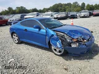 2004 Hyundai Tiburon GT with VIN KMHHN65F44U133018, listed as a Copart auction lot 71449834 with 142,777 mi miles and Salvage title. Bid and sale history available at DreamBid. Image 4.