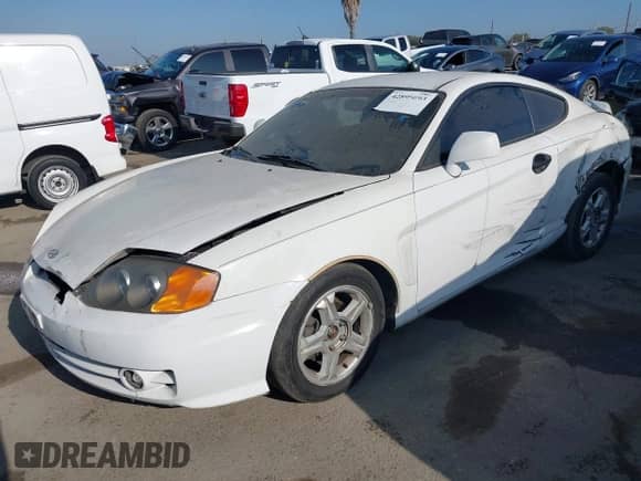 2004 Hyundai Tiburon GS z VIN KMHHM65D64U107599, wystawiony jako IAAI lot #42895093 z przebiegiem 184 234 mil mil oraz . Historia ofert i sprzedaży dostępna na DreamBid. Obrazek 2.