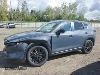 2023 Mazda CX-5 S Carbon Edition z VIN JM3KFBCM1P0249281, wystawiony jako Copart lot #70537745 z przebiegiem 22 623 mil mil oraz Szkoda całkowita • Salvage title. Historia ofert i sprzedaży dostępna na DreamBid. Obrazek 1.