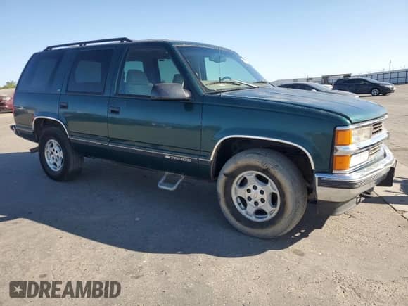 1998 Chevrolet Tahoe with VIN 1GNEK13R0WJ313706, listed as a Copart auction lot 61010445 with 196,671 mi miles and Salvage title. Bid and sale history available at DreamBid. Image 4.