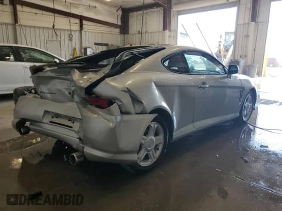 2003 Hyundai Tiburon GT с VIN KMHHN65F53U019155, выставлен на аукционе Copart как лот 67763185 с пробегом 66 114 миль миль и На запчасти • Non repairable. История ставок и продаж доступна на DreamBid. Изображение 3.