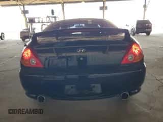 2003 Hyundai Tiburon GT с VIN KMHHN65F23U021493, выставлен на аукционе Copart как лот 68441584 с пробегом 92 848 миль миль и Чистый • Clean title. История ставок и продаж доступна на DreamBid. Изображение 6.