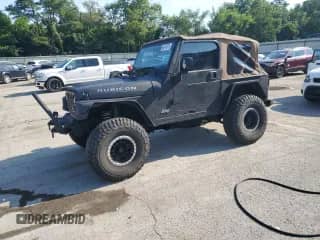 2003 Jeep Wrangler Rubicon z VIN 1J4FA69S23P310588, wystawiony jako Copart lot #66919775 z przebiegiem 106 685 mil mil oraz Szkoda całkowita • Salvage title. Historia ofert i sprzedaży dostępna na DreamBid. Obrazek 1.