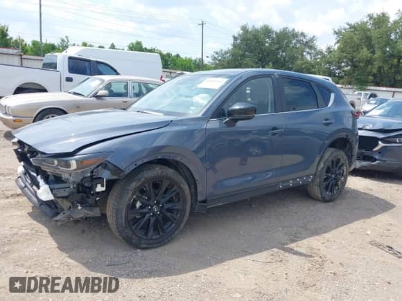 2025 Mazda CX-5 S Carbon Edition z VIN JM3KFBCM4S0679413, wystawiony jako IAAI lot #43019149 z przebiegiem 4 561 mil mil oraz . Historia ofert i sprzedaży dostępna na DreamBid. Obrazek 2.