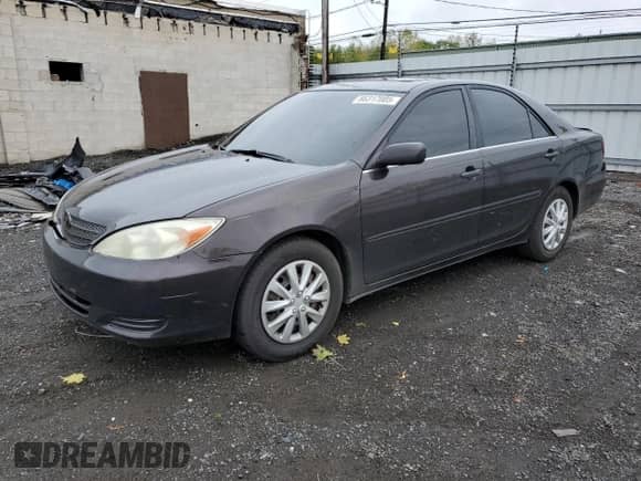 2002 Toyota Camry LE with VIN 4T1BE32K72U508340, listed as a Copart auction lot 86317005 with 216,628 mi miles and Salvage title. Bid and sale history available at DreamBid. Image 1.