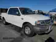 2002 Ford F-150 XLT с VIN 1FTRW07L52KA32293, выставлен на аукционе Copart как лот 81226245 с пробегом 472 017 миль миль и Списание • Salvage title. История ставок и продаж доступна на DreamBid. Изображение 4.