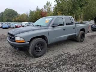 2003 Dodge Dakota Sport with VIN 1D7HL38N63S192308, listed as a Copart auction lot 77494684 with 128,512 mi miles and Salvage title. Bid and sale history available at DreamBid. Image 1.