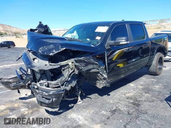 2021 Ram 1500 Laramie with VIN 1C6SRFJTXMN823383, listed as a IAAI auction lot 43353162 with 82,117 mi miles and . Bid and sale history available at DreamBid. Image 2.