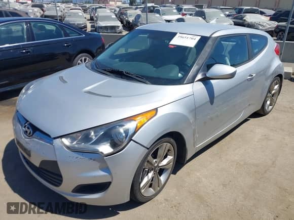2012 Hyundai Veloster w/Gray Int z VIN KMHTC6AD6CU079711, wystawiony jako IAAI lot #41750279 z przebiegiem 154 746 mil mil oraz . Historia ofert i sprzedaży dostępna na DreamBid. Obrazek 2.