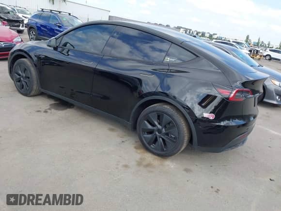 2024 Tesla Model Y with VIN 7SAYGDED8RF156984, listed as a IAAI auction lot 43324819 with 26,941 mi miles and . Bid and sale history available at DreamBid. Image 3.