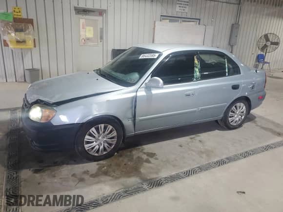 2005 Hyundai Accent GLS z VIN KMHCG45C65U662633, wystawiony jako Copart lot #86432595 z przebiegiem 221 608 mil mil oraz Szkoda całkowita • Salvage title. Historia ofert i sprzedaży dostępna na DreamBid. Obrazek 1.