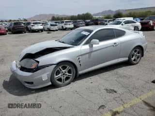 2006 Hyundai Tiburon GT с VIN KMHHN65F06U203701, выставлен на аукционе Copart как лот 52374135 с пробегом 90 796 миль миль и Списание • Salvage title. История ставок и продаж доступна на DreamBid. Изображение 1.
