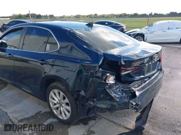 2021 Toyota Camry LE with VIN 4T1C11AK2MU534448, listed as a IAAI auction lot 43111658 with 89,877 mi miles and . Bid and sale history available at DreamBid. Image 6.