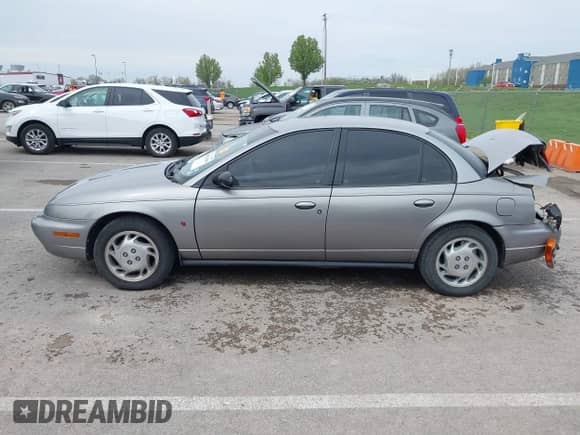 1997 Saturn SL с VIN 1G8ZK527XVZ257477, выставлен на аукционе IAAI как лот 42029648 с пробегом 114 371 миль миль и . История ставок и продаж доступна на DreamBid. Изображение 14.