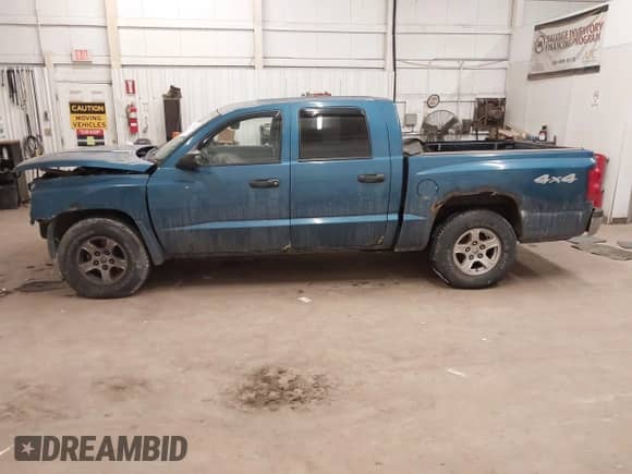 2005 Dodge Dakota SLT with VIN 1D7HW48KX5S306252, listed as a IAAI auction lot 41399238 with 140,474 mi miles and . Bid and sale history available at DreamBid. Image 14.