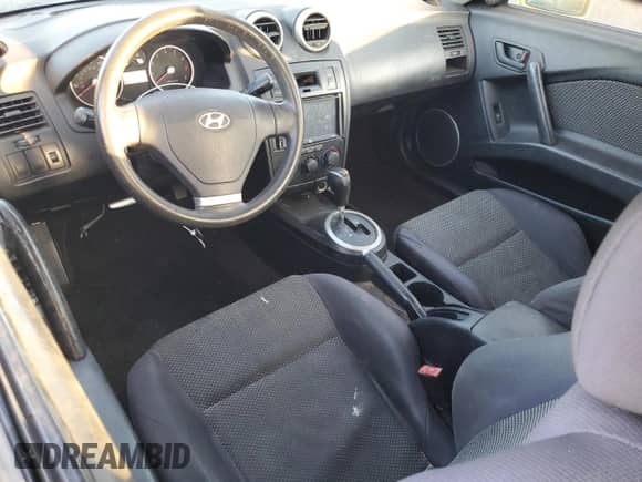 2006 Hyundai Tiburon GS с VIN KMHHM65D36U212295, выставлен на аукционе Copart как лот 88584755 с пробегом 154 372 миль миль и Чистый • Clean title. История ставок и продаж доступна на DreamBid. Изображение 8.