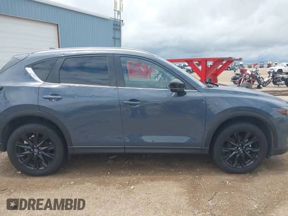 2022 Mazda CX-5 S Preferred z VIN JM3KFBCM8N1581273, wystawiony jako IAAI lot #42568772 z przebiegiem 23 557 mil mil oraz . Historia ofert i sprzedaży dostępna na DreamBid. Obrazek 13.