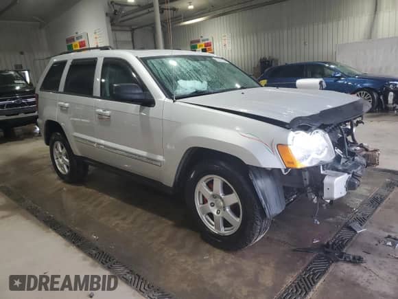 2010 Jeep Grand Cherokee Laredo with VIN 1J4RR4GT7AC141856, listed as a Copart auction lot 83797225 with 61,435 mi miles and Salvage title. Bid and sale history available at DreamBid. Image 4.