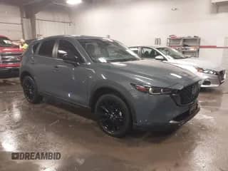 2022 Mazda CX-5 S Carbon Edition z VIN JM3KFBCM3N0527885, wystawiony jako IAAI lot #41226356 z przebiegiem 25 691 mil mil oraz . Historia ofert i sprzedaży dostępna na DreamBid. Obrazek 1.