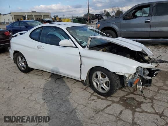 2000 Hyundai Tiburon с VIN KMHJG35F9YU191917, выставлен на аукционе Copart как лот 79629394 с пробегом 179 948 миль миль и Списание • Salvage title. История ставок и продаж доступна на DreamBid. Изображение 4.