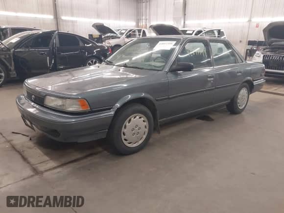 1991 Toyota Camry DLX z VIN 4T1SV21E1MU391430, wystawiony jako IAAI lot #42897399 z przebiegiem 151 914 mil mil oraz . Historia ofert i sprzedaży dostępna na DreamBid. Obrazek 2.