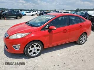 2012 Ford Fiesta SEL with VIN 3FADP4CJ2CM103825, listed as a Copart auction lot 67818615 with 142,234 mi miles and Salvage title. Bid and sale history available at DreamBid. Image 1.