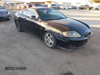 2006 Hyundai Tiburon GS z VIN KMHHM65DX6U217882, wystawiony jako IAAI lot #43576572 z przebiegiem 158 336 mil mil oraz . Historia ofert i sprzedaży dostępna na DreamBid. Obrazek 1.