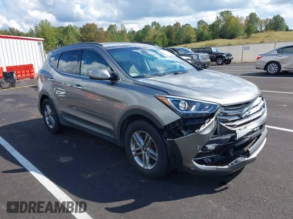 2018 Hyundai Santa Fe 2.4L z VIN 5NMZU3LBXJH098272, wystawiony jako IAAI lot #43375252 z przebiegiem 96 576 mil mil oraz . Historia ofert i sprzedaży dostępna na DreamBid. Obrazek 1.