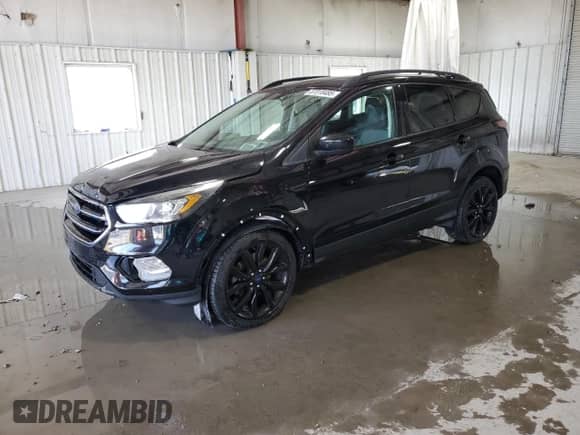 2018 Ford Escape SE with VIN 1FMCU9GD2JUC25153, listed as a Copart auction lot 87018485 with 104,172 mi miles and Salvage title. Bid and sale history available at DreamBid. Image 1.
