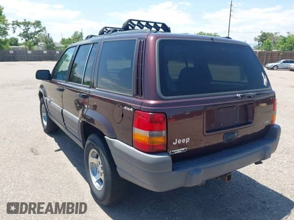 1996 Jeep Grand Cherokee Laredo z VIN 1J4GZ58Y2TC354076, wystawiony jako IAAI lot #42572842 z przebiegiem 172 282 mil mil oraz . Historia ofert i sprzedaży dostępna na DreamBid. Obrazek 3.