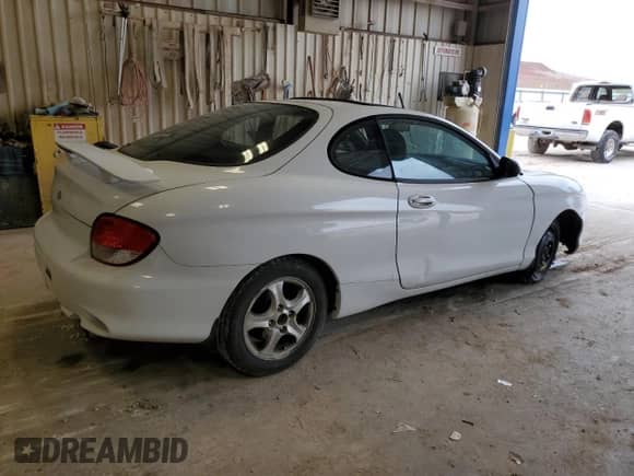 2000 Hyundai Tiburon with VIN KMHJG25F1YU217419, listed as a Copart auction lot 54772515 with 155,023 mi miles and Salvage title. Bid and sale history available at DreamBid. Image 3.